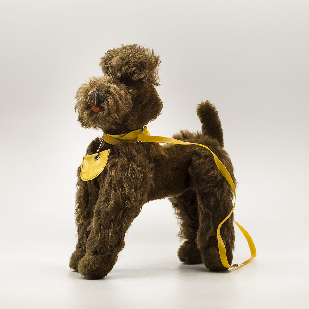 Stuffed poodle dog. Bendable legs, stands on its own with original plastic leash.